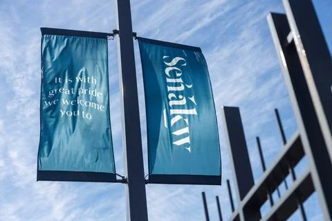 Senkw development welcome banners in teal mounted on a street pole near Bur.. Stock Photos