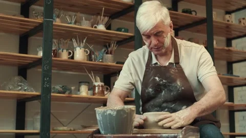 Senor man makes a cup during pottery. Stock Footage 157652376