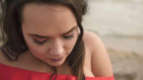 Sensitive beautiful plus size model at the beach in red dress Stock Footage 110850400