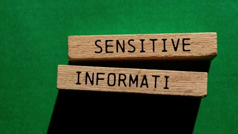 Sensitive information message writing on wooden blocks on green background Stock Footage 283731443
