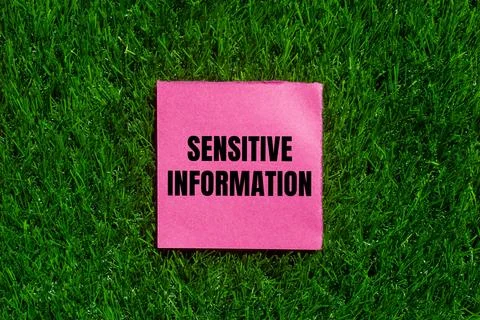Sensitive information message written on ripped torn pink paper with green gr 스톡 사진