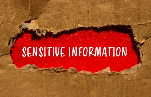Sensitive information message written on torn cardboard paper with red backgr 스톡 사진