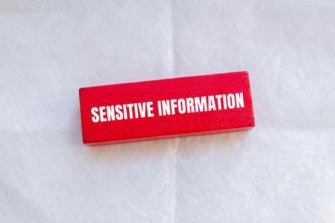 Sensitive information words written on red wodoen block with white background Stock Photos