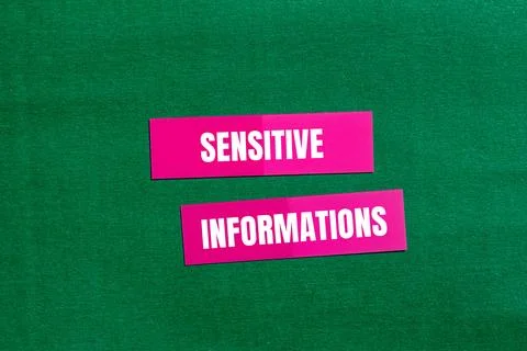 Sensitive informations message written on pink paper with green background. C Foto stock