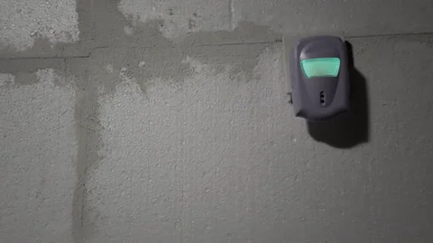 Sensor detects motion at a warehouse entrance during night hours while lights Stock Footage 342369358