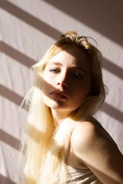 A sensual blonde, looking at camera, lighted by the sun Stock Photos