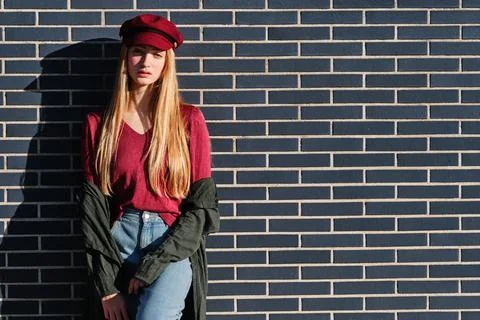 Sensual blonde model posing leaning on an urban wall Stock Photos