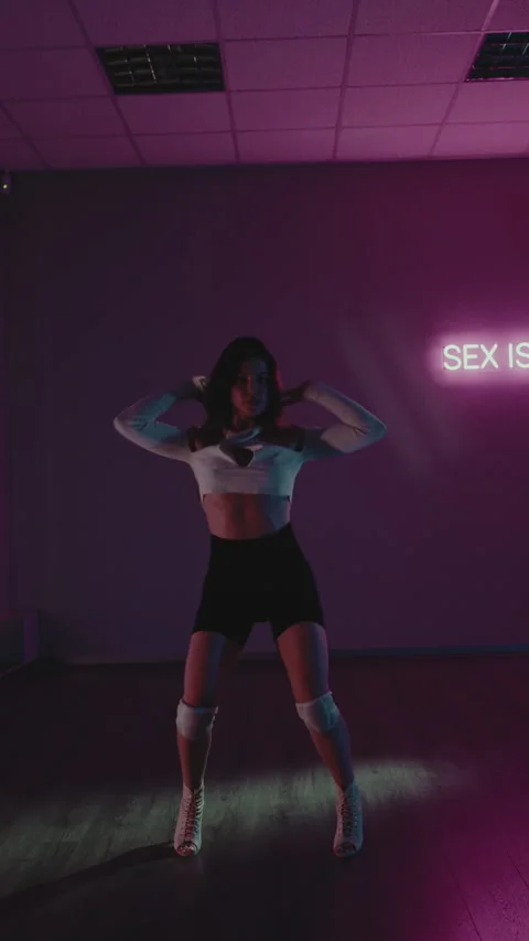 Sensual Dance in Neon Lit Studio. Woman Expresses Passion Through Rhythmic Stock Footage 342804564