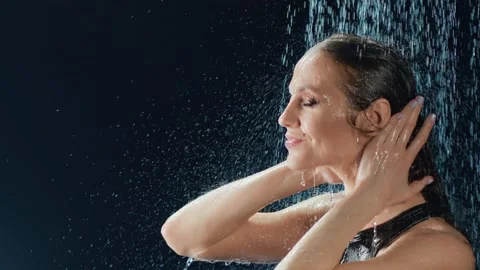 Sensual lady stand surrounded by rain drops touch wet body. Shot on RED Raven 4k Stock Footage 131590724