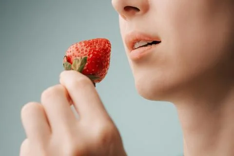 Sensual lips and strawberries. Stock Photos