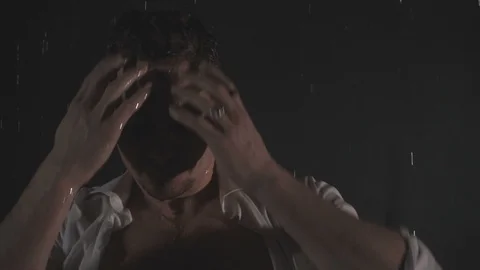 Sensual man in falling drops of water. Slow motion 스톡 동영상 105679487