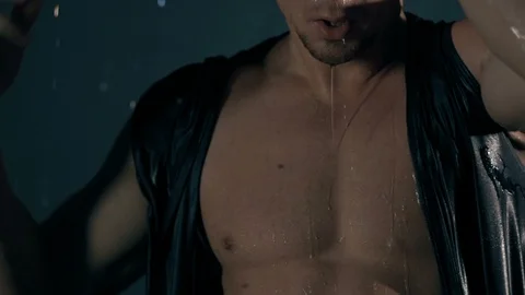 Sensual man in falling drops of water. Slow motion Stock Footage 122018924
