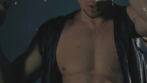 Sensual man in falling drops of water. Slow motion Stock Footage 122019069