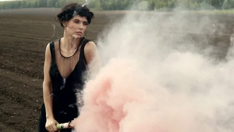 Sensual model with colored smoke on nature Видео 76203872