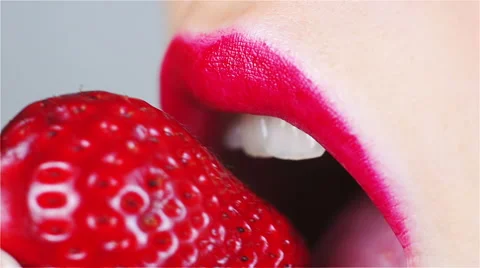 Sensual Red Lips Bite Strawberry Stock Footage 49755469