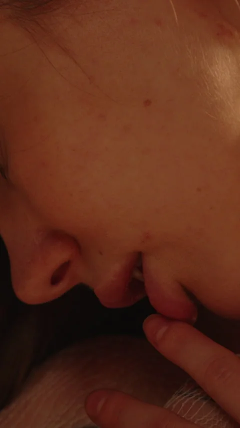 Sensual vertical close up of the mouth and lips of an attractive woman moving Stock Footage 333613060
