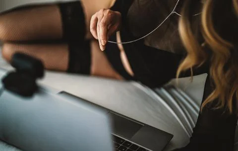 Sensual webcam model performing live stream on laptop. Фото