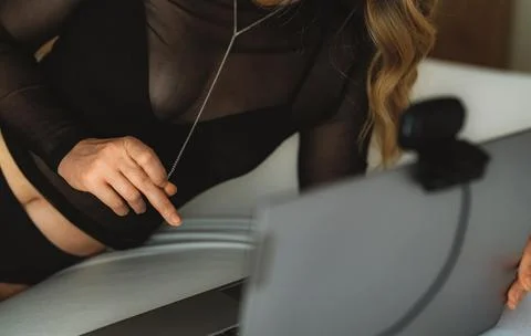Sensual webcam model performing live stream on laptop. Фото