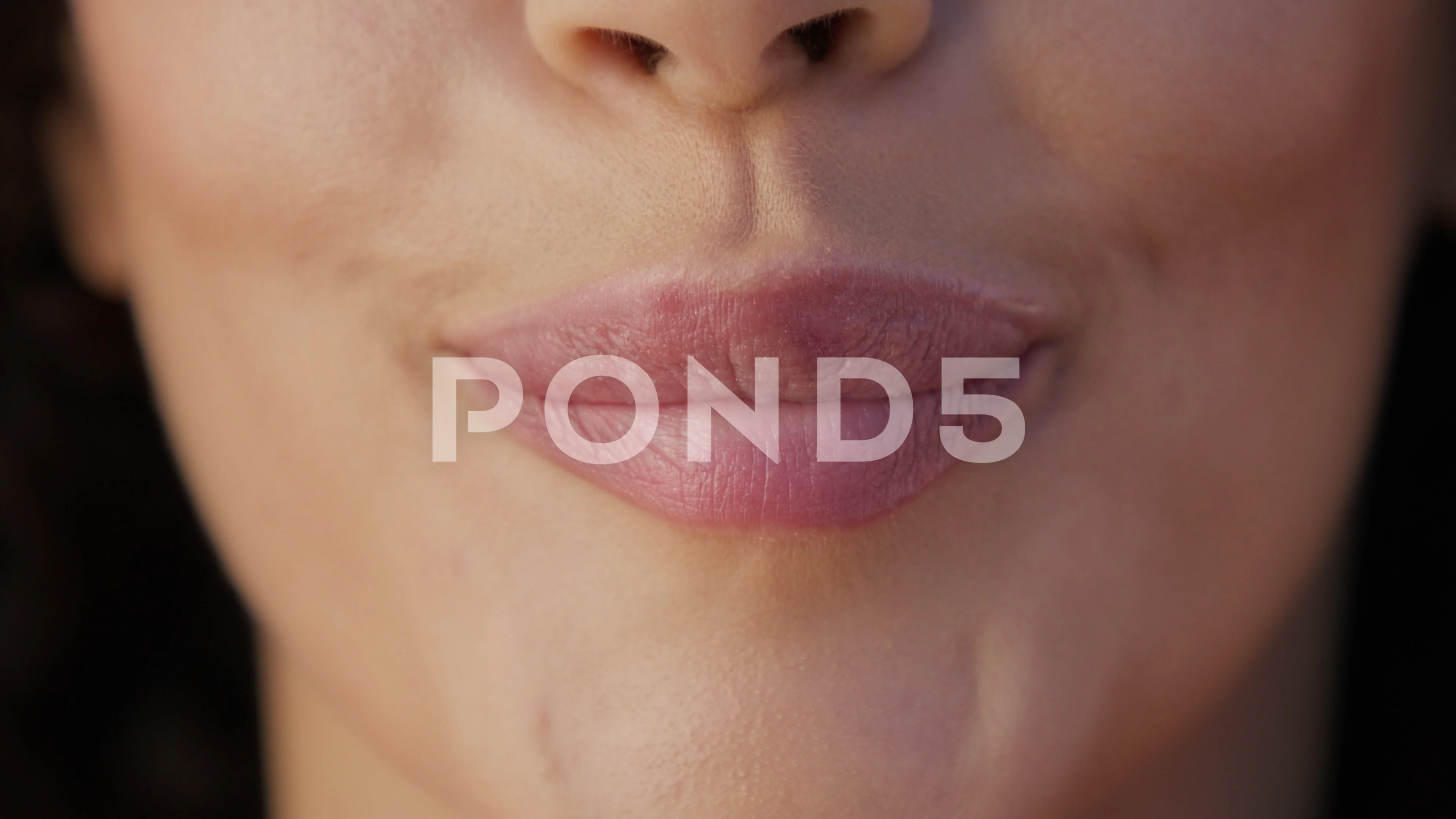 Sensual woman licking plump lips and sexually biting, Close up young woman  face