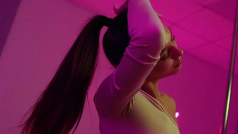 Sensual woman performing pole dance routine Stock Footage 326318600