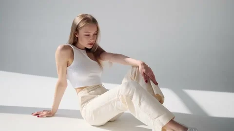 Sensual woman posing while sitting on floor Stock Footage 164536260