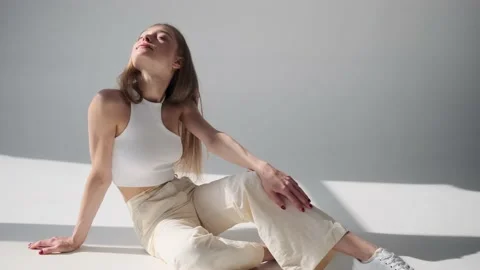 Sensual woman posing while sitting on floor with eyes closed Stock Footage 164538575