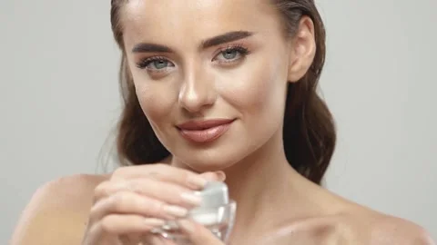Sensual woman using cream for her face Stock Footage 146231753