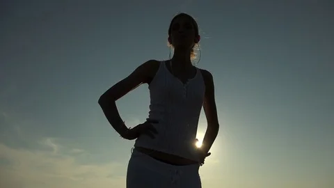Sensual woman's silhouette dancing at the sunset Stock Footage 77556823