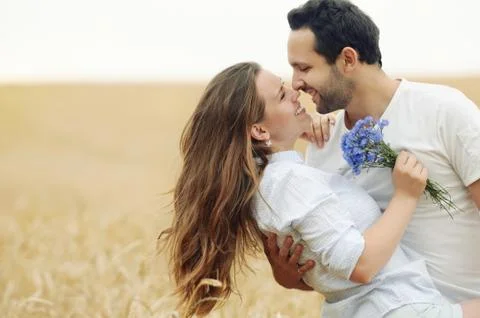 Sensual young couple having fun outdoor in summer field Stock Photos