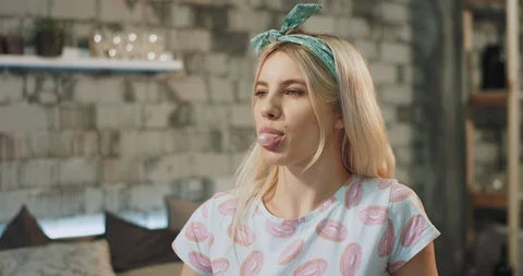 A sensuality lady with a attractive faces eating a gun and make bubbles very Video stock 107787853