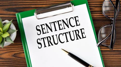SENTENCE STRUCTURE - words on a white sheet on a brown wooden background wi.. Stock Photos