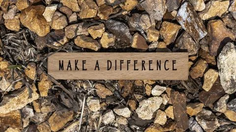 The sentence We believe in making a difference was written. Wooden concept .. Stock Photos