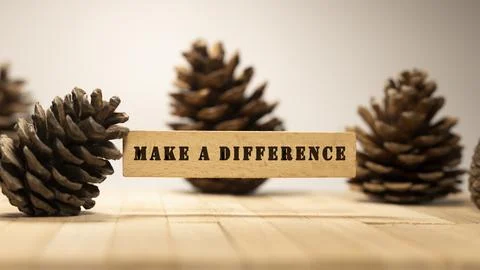 The sentence We believe in making a difference was written. Wooden concept .. Stock Photos