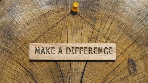 The sentence We believe in making a difference was written. Wooden concept .. Stock Photos