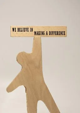The sentence We believe in making a difference was written. Wooden concept .. Stock Photos