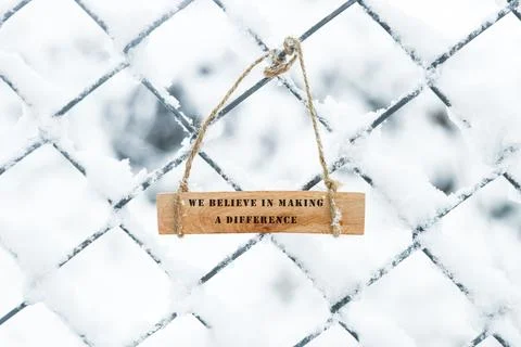 The sentence We believe in making a difference was written. Wooden concept .. Stock Photos
