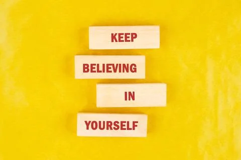The sentiment keep believing in yourself is spelled out using individual wood Stock Photos