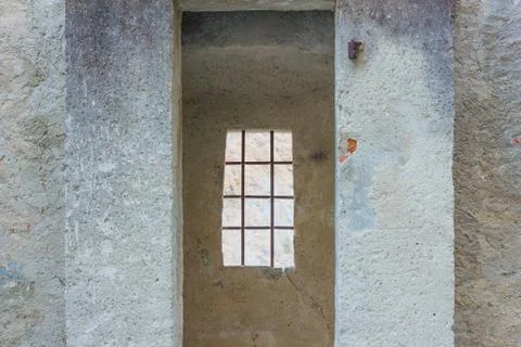 The sentinel room with the window with security grating of an ancient castle Stock Photos