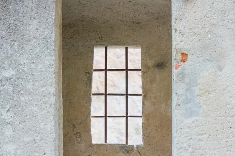 The sentinel room with the window with security grating of an ancient castle Stock Photos