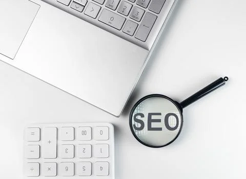 SEO budget concept, search engine optimization. Word through magnifying glass Stock Photos