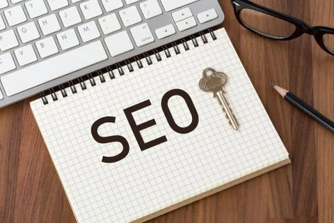 Seo concept with key on notebook Stock Photos