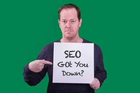 SEO got you down? sign held by adult man pointing at sign Stock Photos