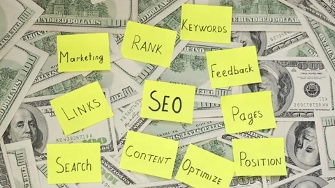SEO optimization notes on the money. A lot of dollar bills and various notes Stock Footage 136033609