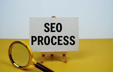 SEO process text on paper card with magnifying glass on yellow background Stock Photos