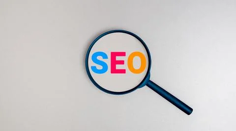 SEO Search Engine Optimization concept, Magnifying glass with text SEO. Stock Photos