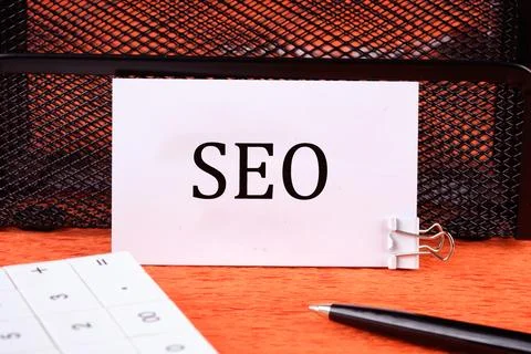 SEO Search Engine Optimization symbol on a clean white business card next to  Foto stock