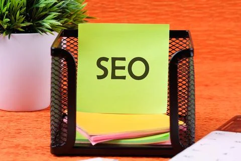 SEO Search Engine Optimization symbol on a sticker in a stand on an orange ba Foto stock