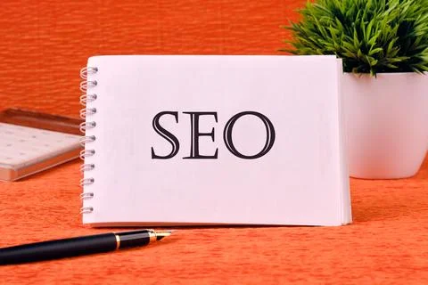 SEO Search Engine Optimization symbol on a white sheet of a notebook. Busin.. Stock Photos