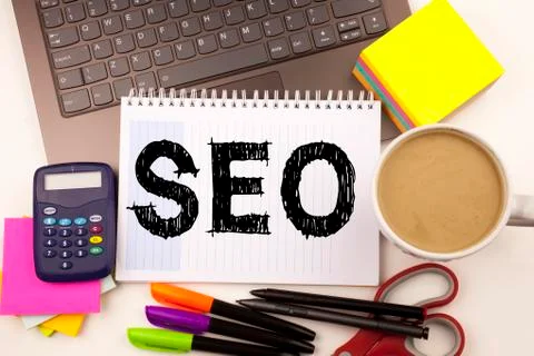SEO Search Engine Optimization text in the office with surroundings such as l Stock Photos