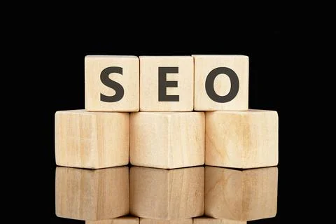 SEO Search Engine Optimization text on wooden cubes on a black background Stock Photos